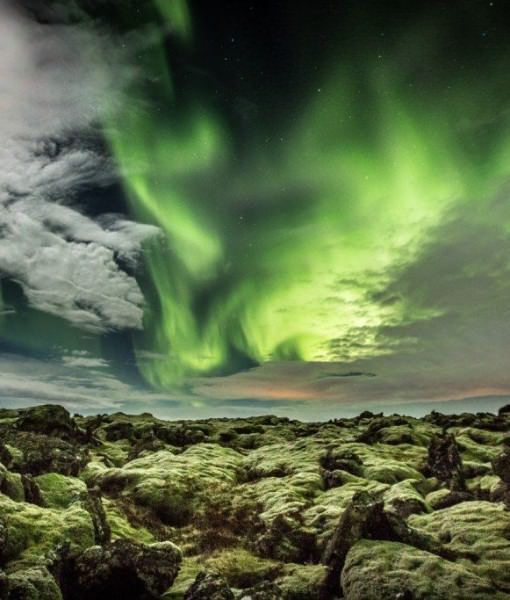 The lava in Iceland is both rough and tender with its soft moss. The aurora among the clouds in the sky shows the beauty of evenings in Iceland.